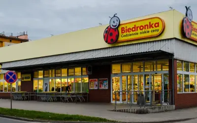 Sklep Biedronka z charakterystycznym logo. Dowiedz się, jak zarejestrować kartę Moja Biedronka, by korzystać z promocji.