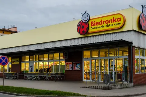 Sklep Biedronka z charakterystycznym logo. Dowiedz się, jak zarejestrować kartę Moja Biedronka, by korzystać z promocji.