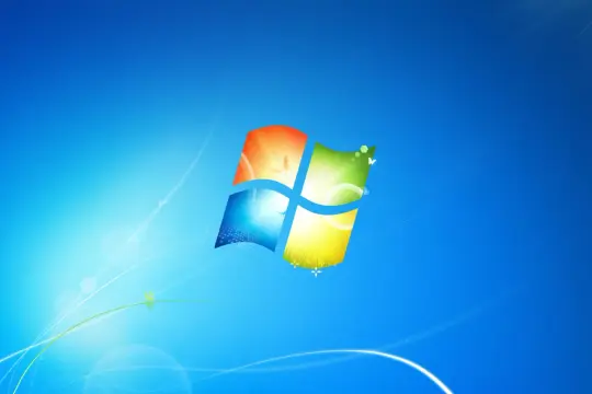 Ikona Windows 7 na niebieskim tle. Dowiedz się, jak zaktualizować Windows 7 do 10, aby cieszyć się nowymi funkcjami.